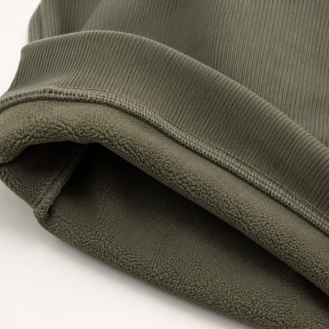 Close-up of the brushed lining at the hem of the green Alcott sweater