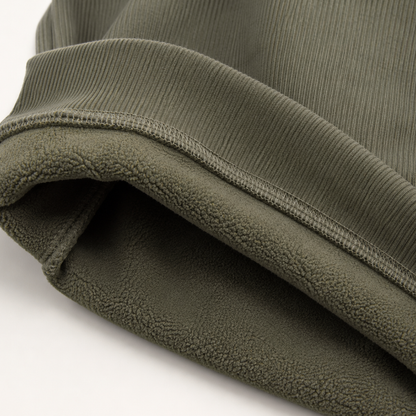 Close-up of the brushed lining at the hem of the green Alcott sweater