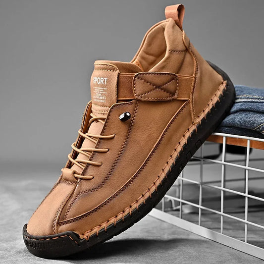 Brown slip-on casual shoe with hand-stitched sides and elastic laces