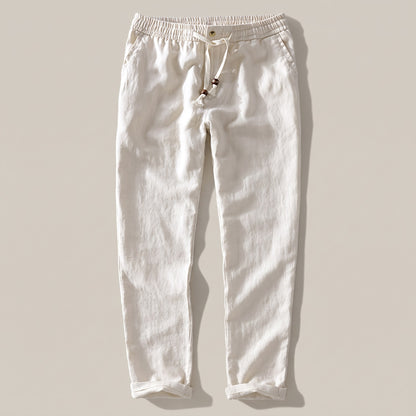Men's cream drawstring pants with an elastic waist and rolled hem, front view
