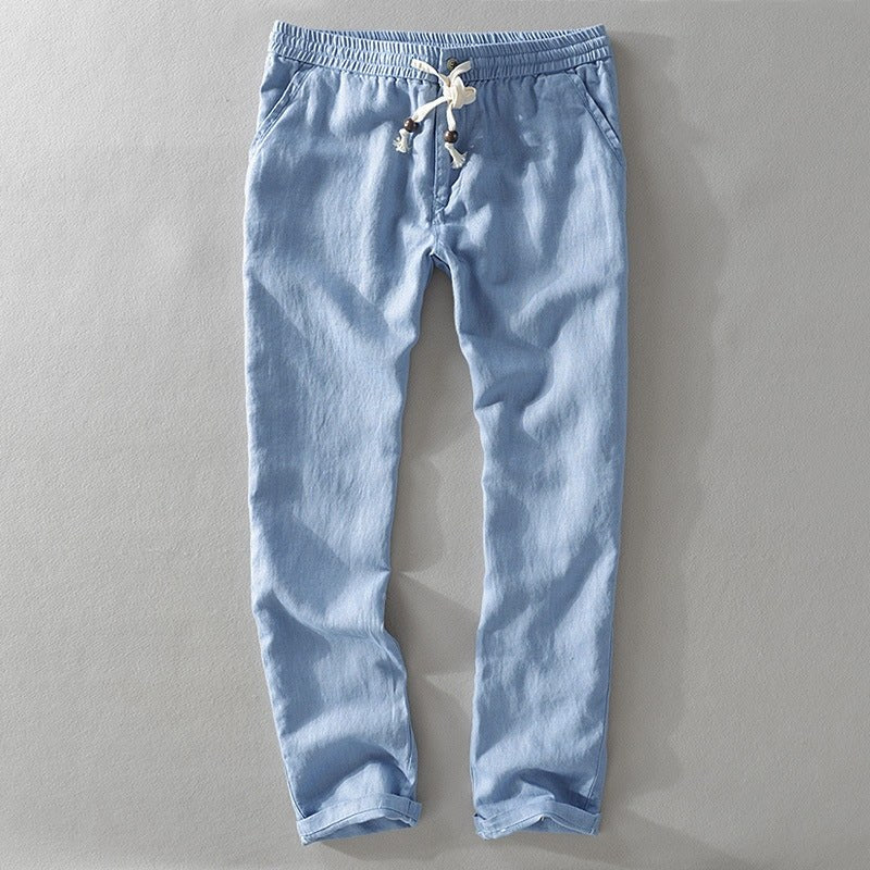 Light blue drawstring pants laid flat with a rolled hem