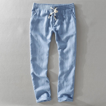 Light blue drawstring pants laid flat with a rolled hem