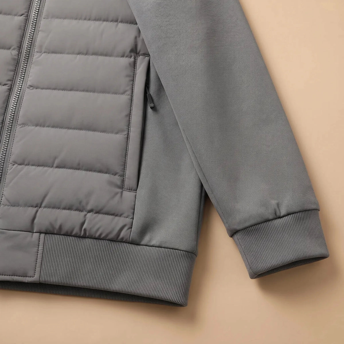 Men's hybrid puffer jacket zip pocket and ribbed cuff close-up