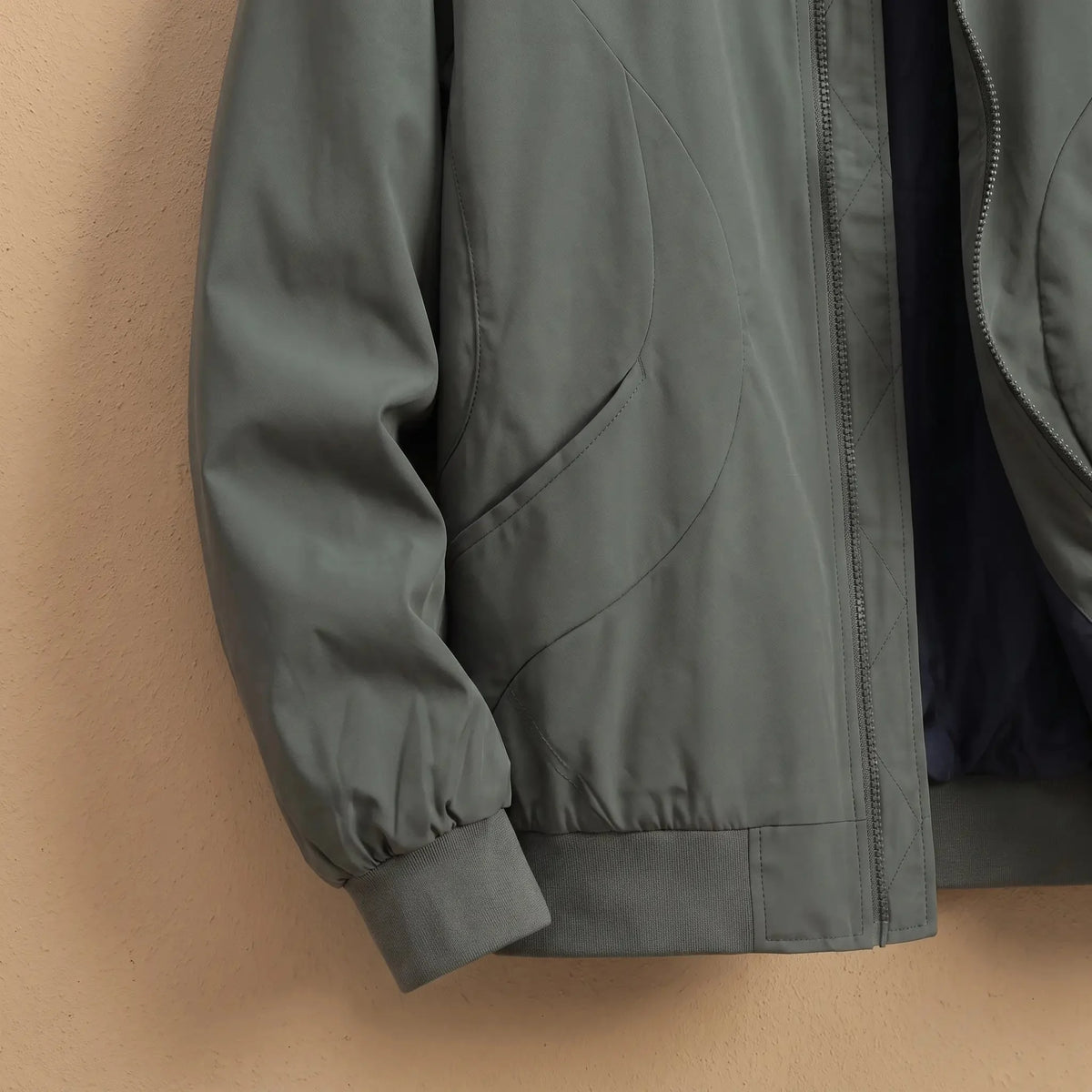 Men's lightweight bomber jacket pocket and ribbed hem close-up