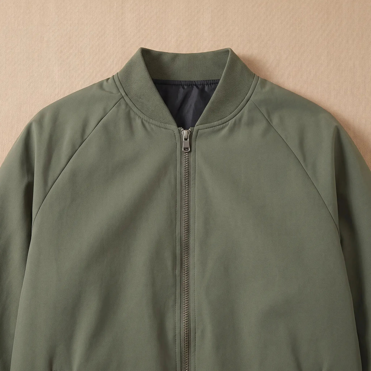 Men's padded bomber jacket ribbed collar and zip close-up
