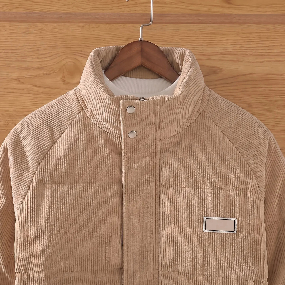 Men's padded corduroy puffer jacket stand collar and throat snaps close-up