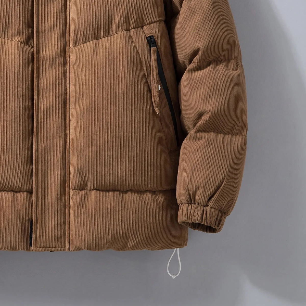 Men's padded puffer jacket zip pocket and drawcord hem close-up