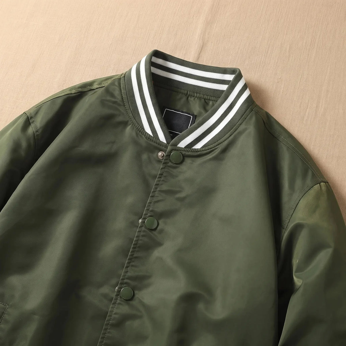 Men's snap front bomber jacket collar and snap front close-up