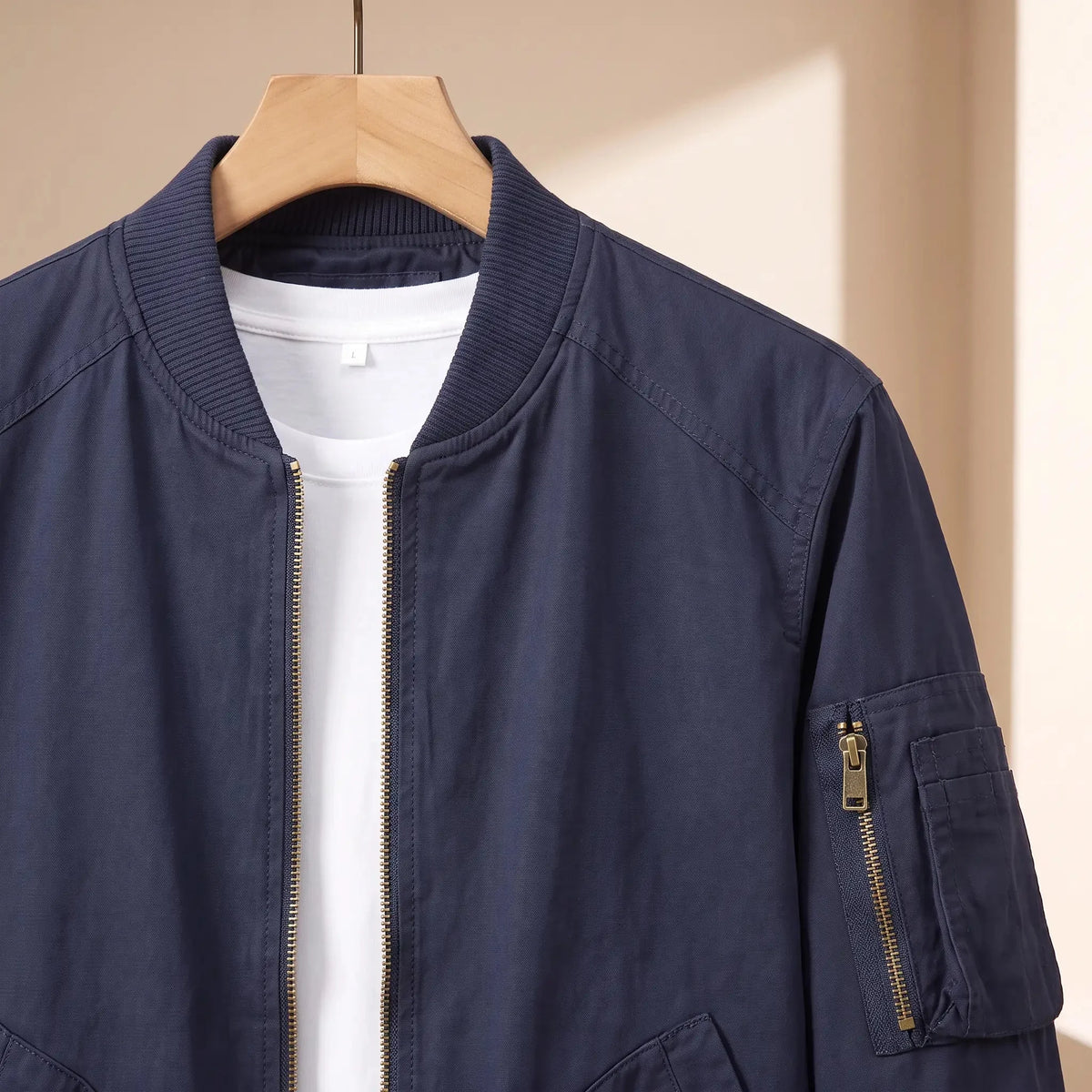 Men's washed bomber jacket sleeve zip pocket close-up