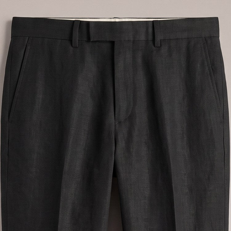 Close view of the waistband and pocket on the black trousers