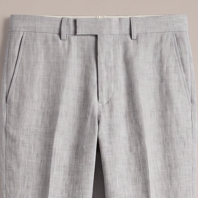 Close view of the waistband and pocket on the light grey trousers
