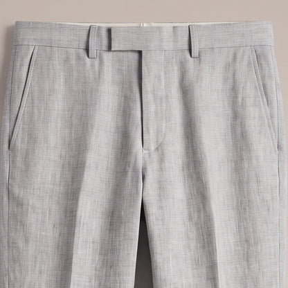 Close view of the waistband and pocket on the light grey trousers
