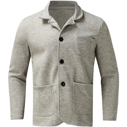 Light grey unstructured blazer laid flat with three black buttons and patch pockets