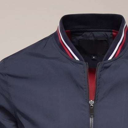 Close view of the striped collar and zip on the bomber jacket