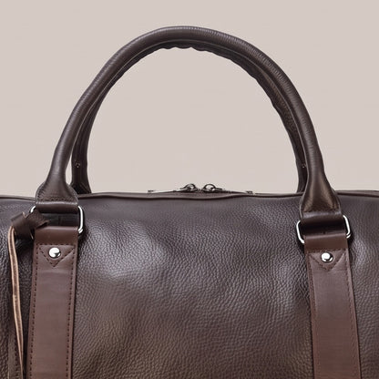 Close view of the top handle and strap on the weekender duffle bag