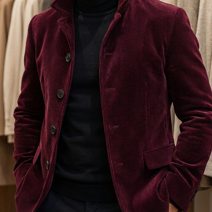 Burgundy men's corduroy-look button jacket worn over a black roll neck
