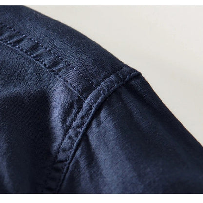 Close view of the shoulder seam and fabric on the navy shirt