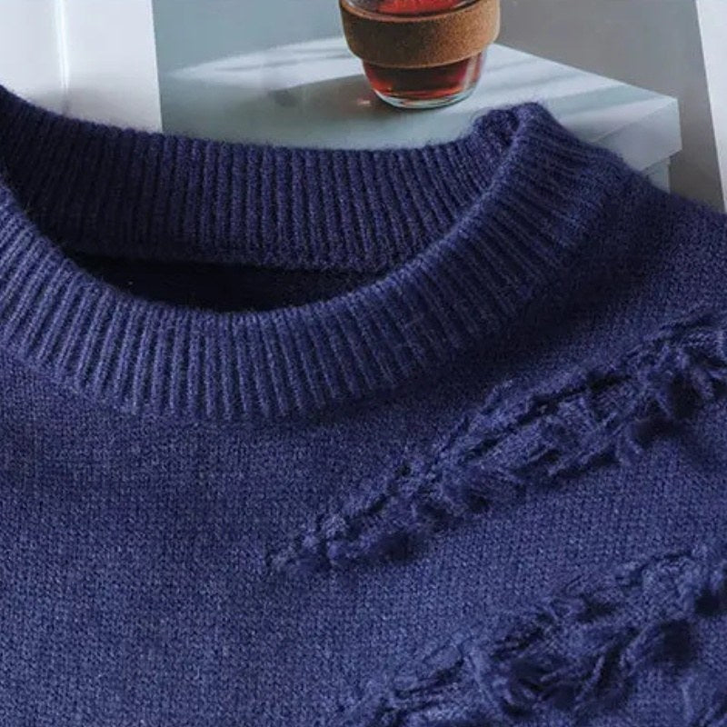 Close view of the ribbed neckline and distressed knit on the blue knit