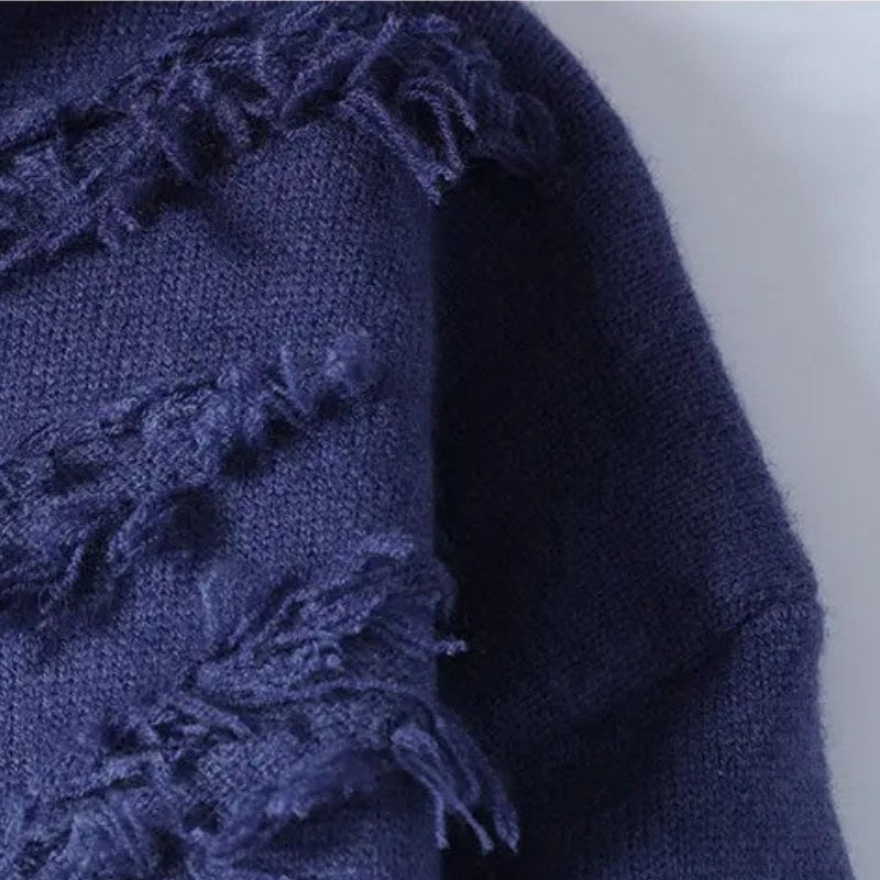 Close view of the distressed raised knit texture