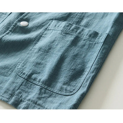 Close view of a patch pocket and button on the blue blazer