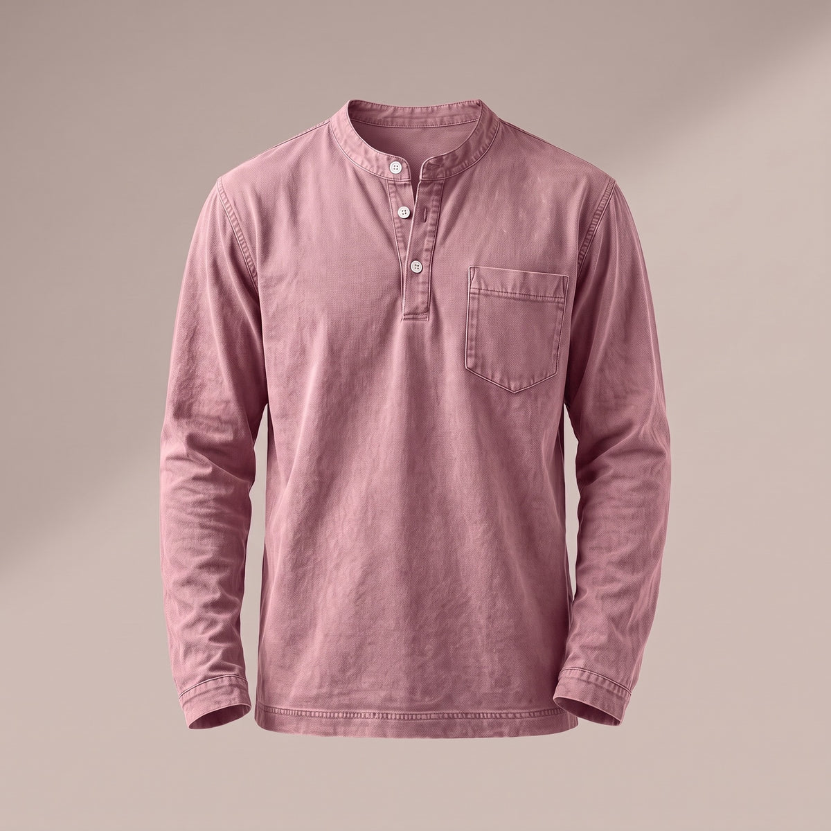 Washed dusty pink long sleeve henley with a three-button placket and a chest pocket, front view