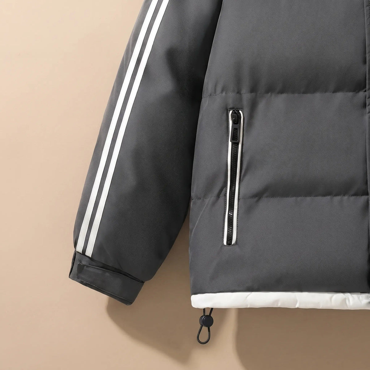 Sleeve stripes, zip pocket and hem toggle of the men's puffer jacket