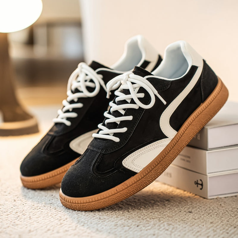 Pair of Gresham sneakers in Black on a display box