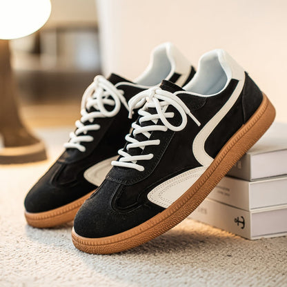 Pair of Gresham sneakers in Black on a display box
