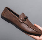 Halsey bar loafers in brown, held to show the side profile