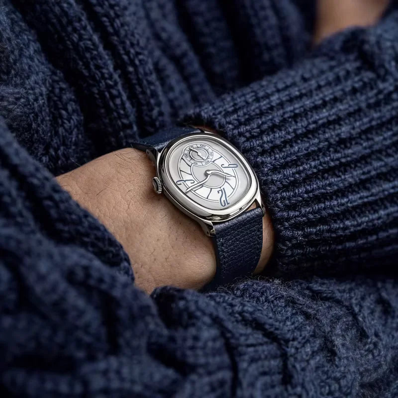 Harcourt silver-toned oval watch with a dark knit sleeve