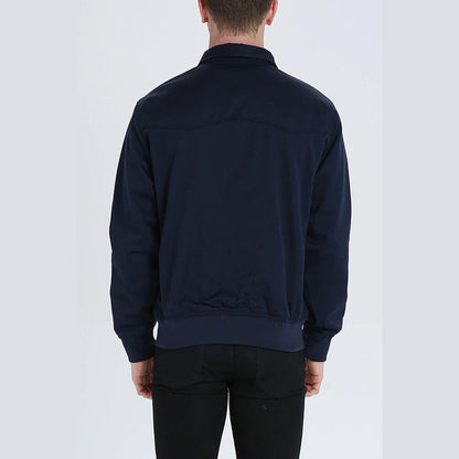 Back of the dark jacket worn by a man with a smooth panel and ribbed hem