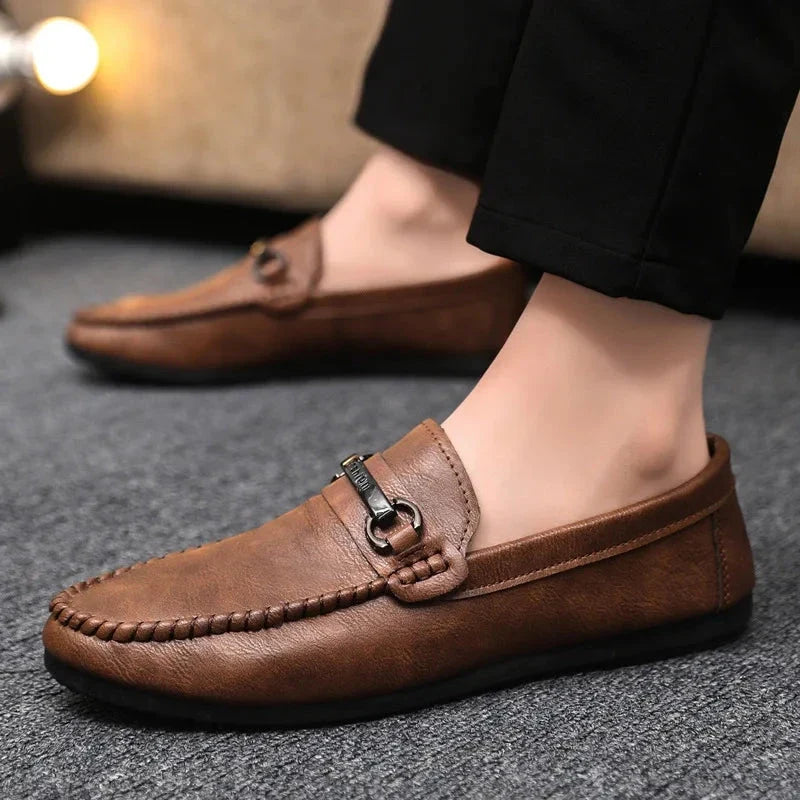 Halsey bar loafers in brown, worn with dark trousers