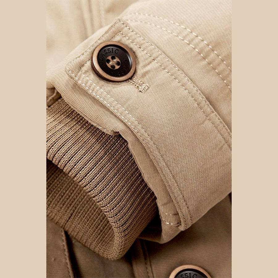Close view of a buttoned cuff with a knitted inner band