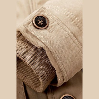 Close view of a buttoned cuff with a knitted inner band