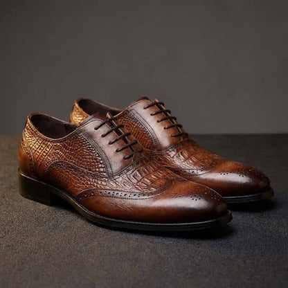 Pair of Kendrick brogue oxfords on a dark studio floor