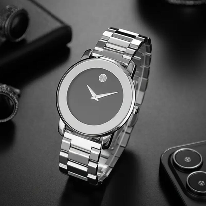 Silver Larkin watch front view on a dark desk