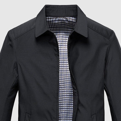 Close view of the turned-down collar and lining on the black jacket