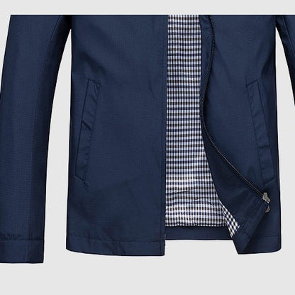 Close view of the zip and side pocket on the navy jacket
