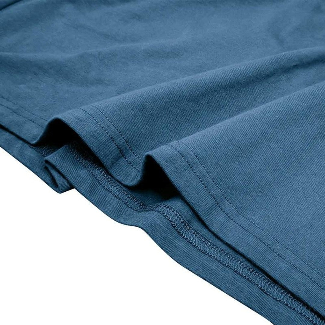Close view of the stitched hem edge on the polo fabric