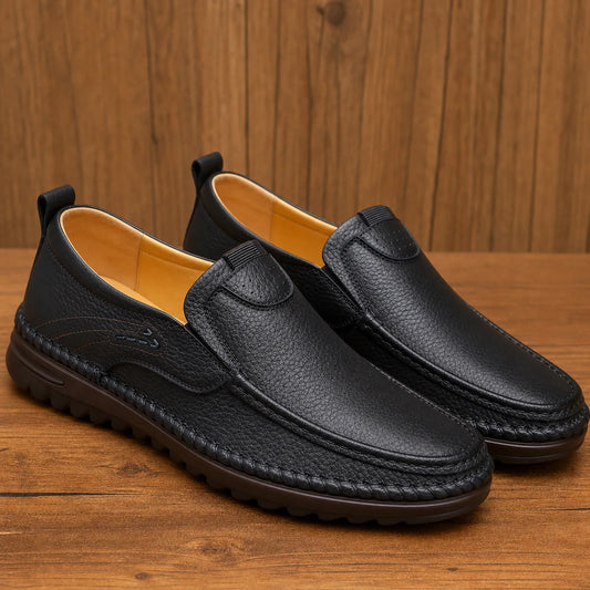 LuxeMove Soft Shoes in black on warm wood background