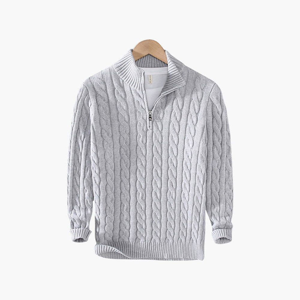Front view of the cable-knit half-zip sweater on a hanger