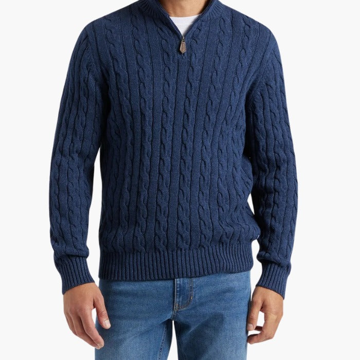Torso view of the cable-knit half-zip sweater worn with jeans, face not shown