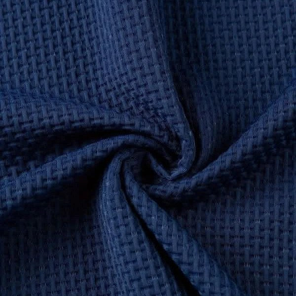Close view of the woven waffle texture of the polo fabric