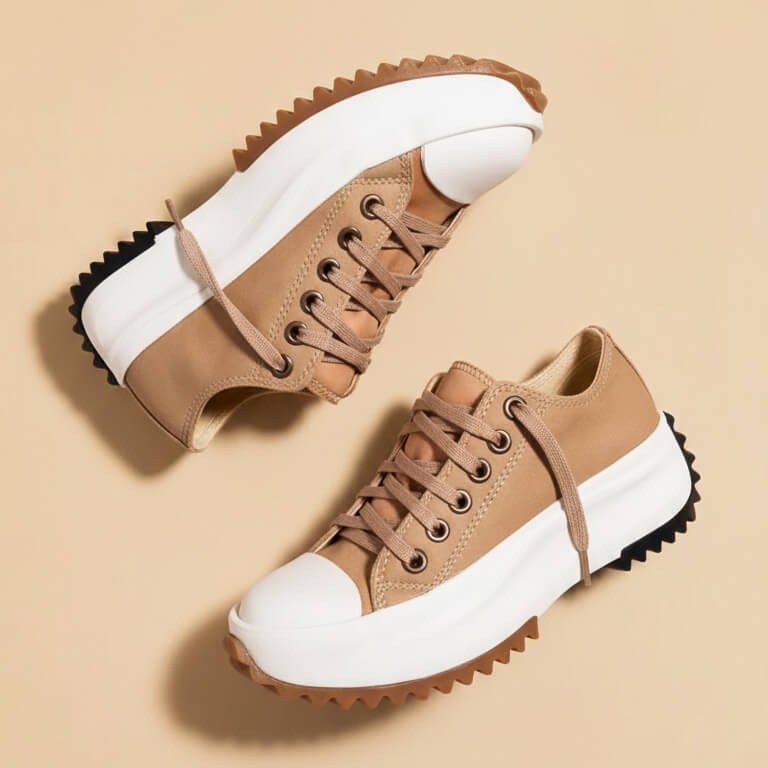 Pair of tan platform sneakers with white soles seen from above