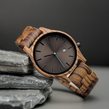 Rutledge walnut wood watch resting against slate stones