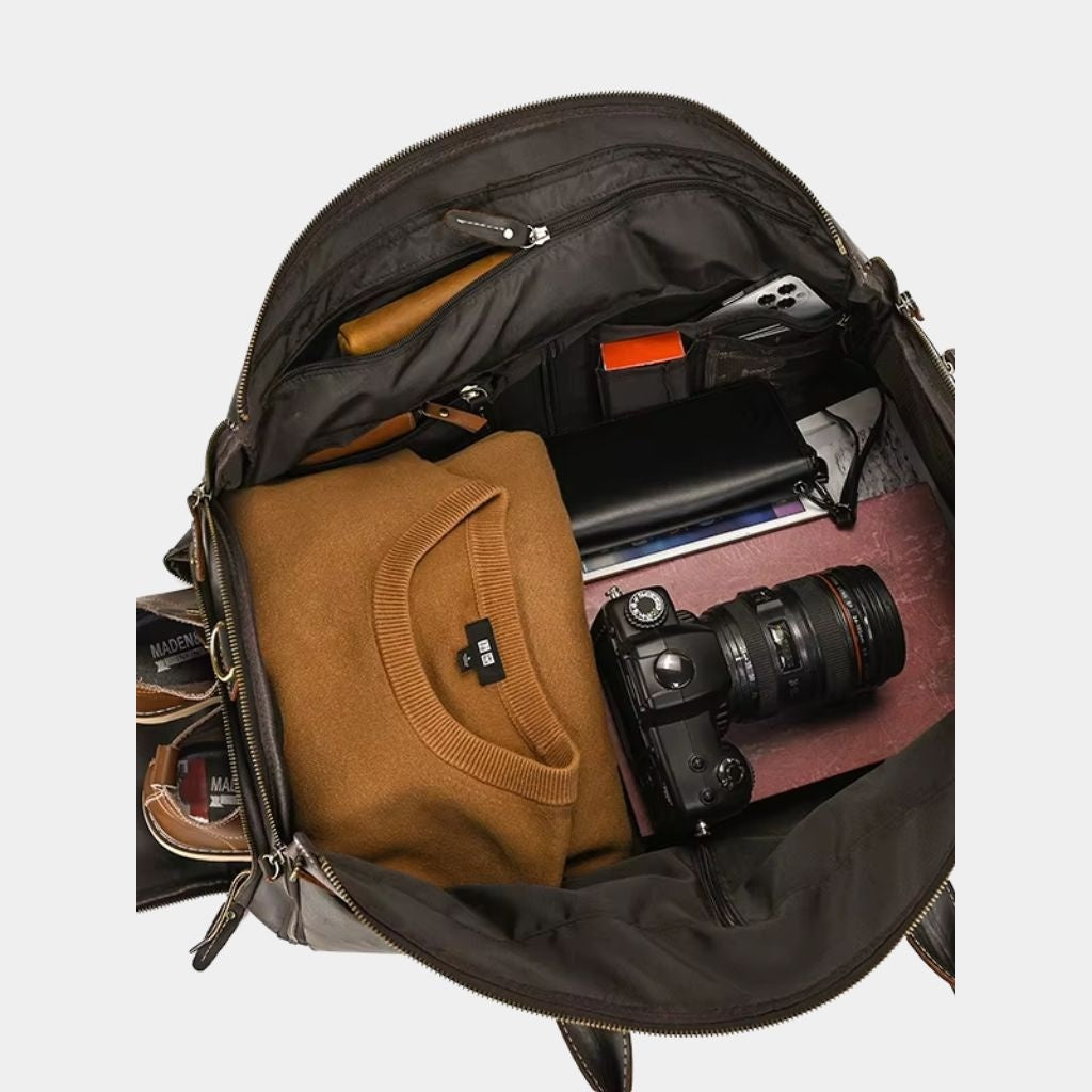 Open interior of the Sheffield duffle packed with a camera and clothes