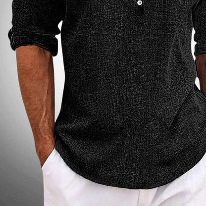 Close view of the rolled sleeve and woven texture on the black henley