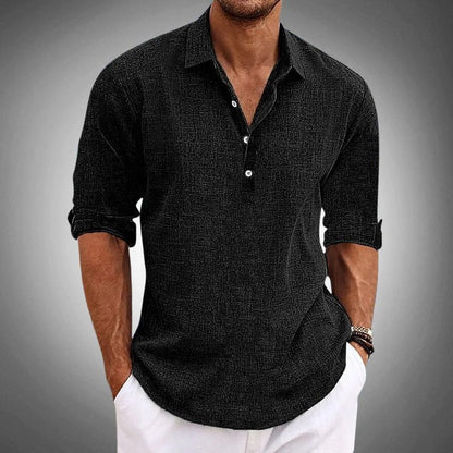 Black textured henley worn with white trousers, cropped below the chin