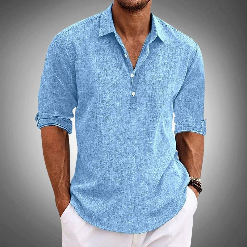 Blue textured henley worn with white trousers, cropped below the chin