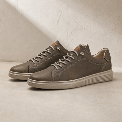 Torino Leather Trainers in Brown on clean studio stone